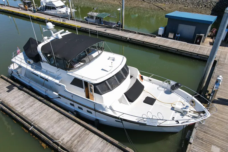 Slide: The Image of 1999 Grand Alaskan Pilothouse yacht docked at marina, featuring sleek design and spacious deck. - 71