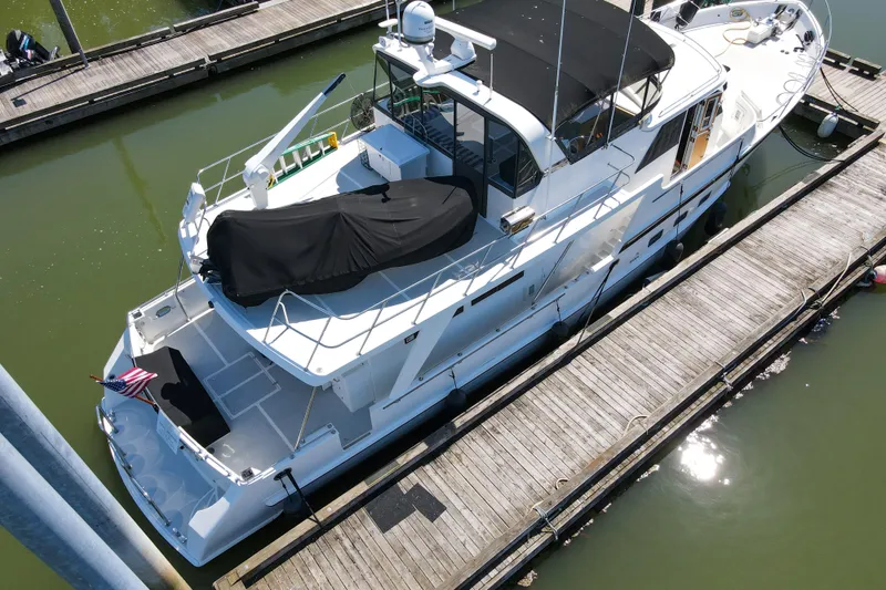 Slide: The Image of Aerial view of 1999 Grand Alaskan Pilothouse yacht docked at marina. - 72