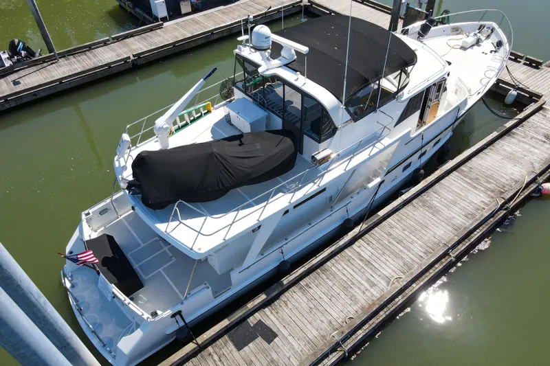 Slide: The Image of 1999 Grand Alaskan Pilothouse yacht docked at marina, aerial view. - 73