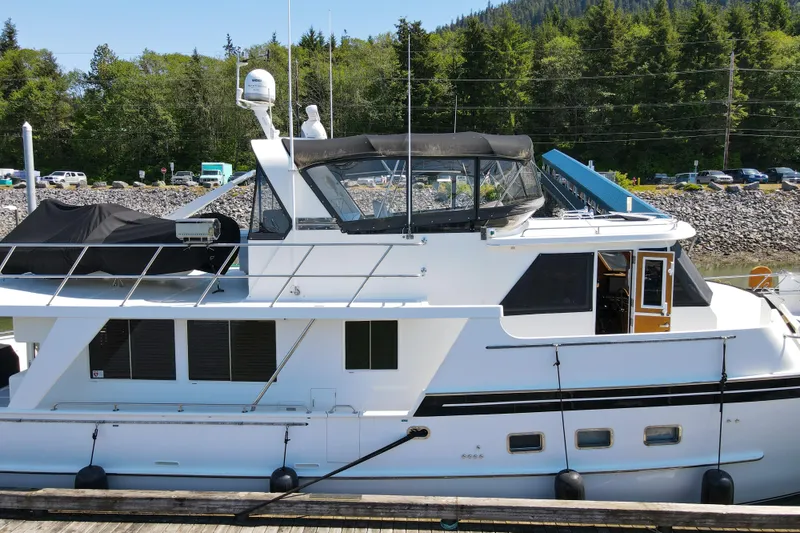 Slide: The Image of 1999 Grand Alaskan Pilothouse yacht docked, featuring sleek design and modern amenities. - 81