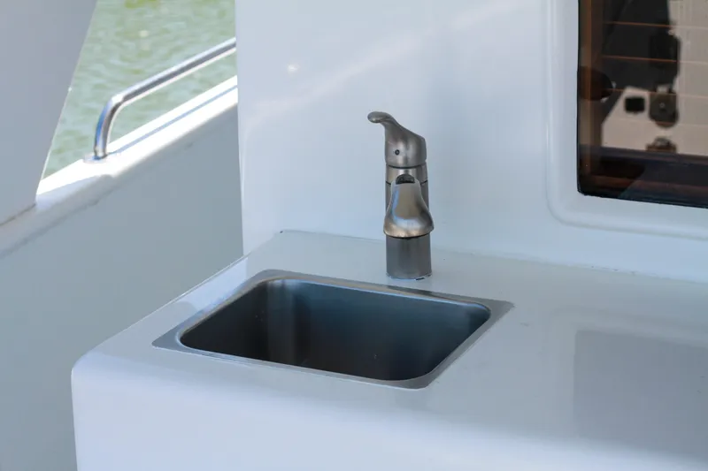 Slide: The Image of Stainless steel sink and faucet on 1999 Grand Alaskan Pilothouse yacht. - 84