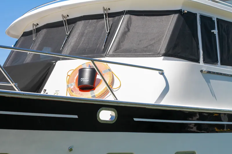 Slide: The Image of 1999 Grand Alaskan Pilothouse yacht with lifebuoy and bucket on deck. - 88