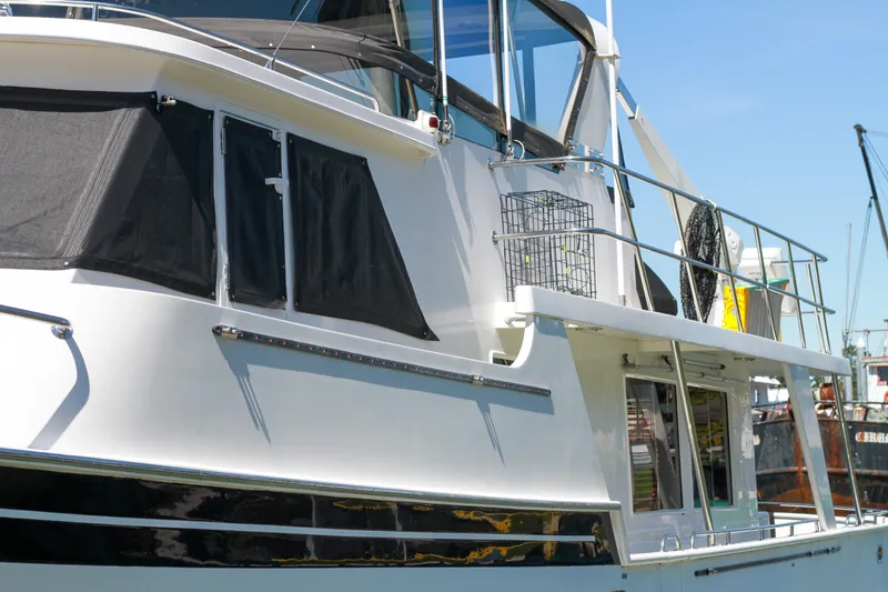 Slide: The Image of 1999 Grand Alaskan Pilothouse yacht docked, featuring sleek design and modern amenities. - 89