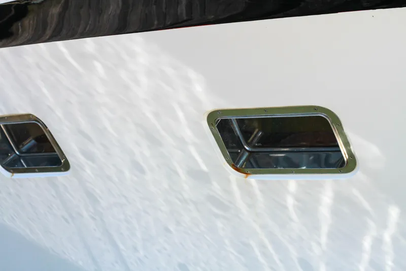 Slide: The Image of 1999 Grand Alaskan Pilothouse boat windows reflecting sunlight on white hull. - 90