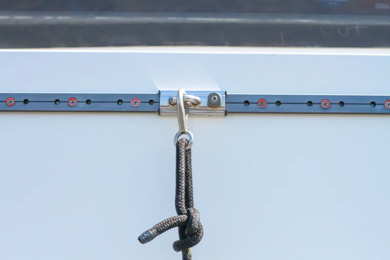Slide: The Image of Close-up of a 1999 Grand Alaskan Pilothouse boat's cleat with a secured rope. - 93