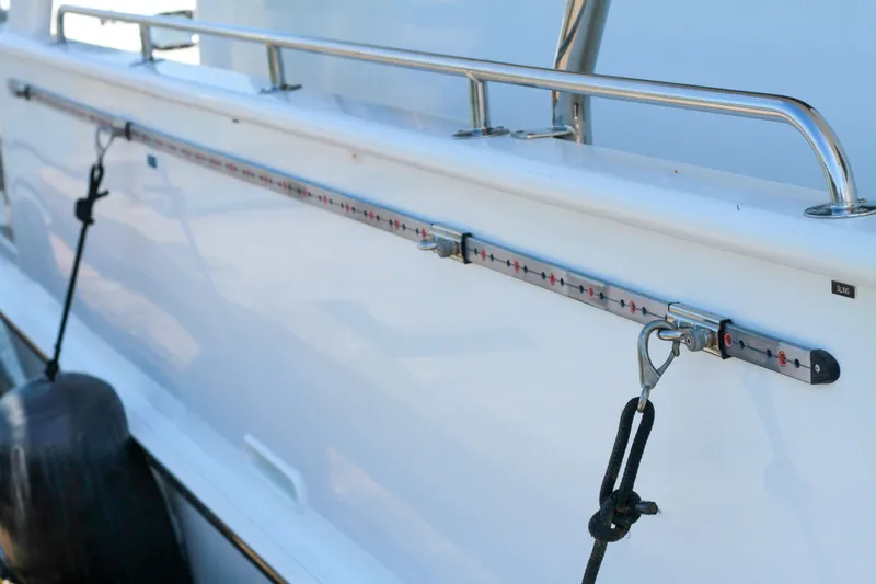 Slide: The Image of Side view of 1999 Grand Alaskan Pilothouse boat with railing and fender. - 94