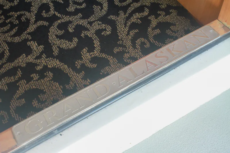 Slide: The Image of Grand Alaskan Pilothouse 1999 door sill with decorative carpet background. - 96