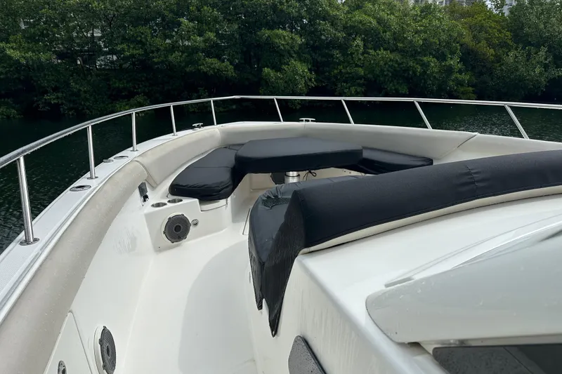 Slide: The Image of 2020 Boston Whaler 420 Outrage boat interior with cushioned seating and railing. - 12