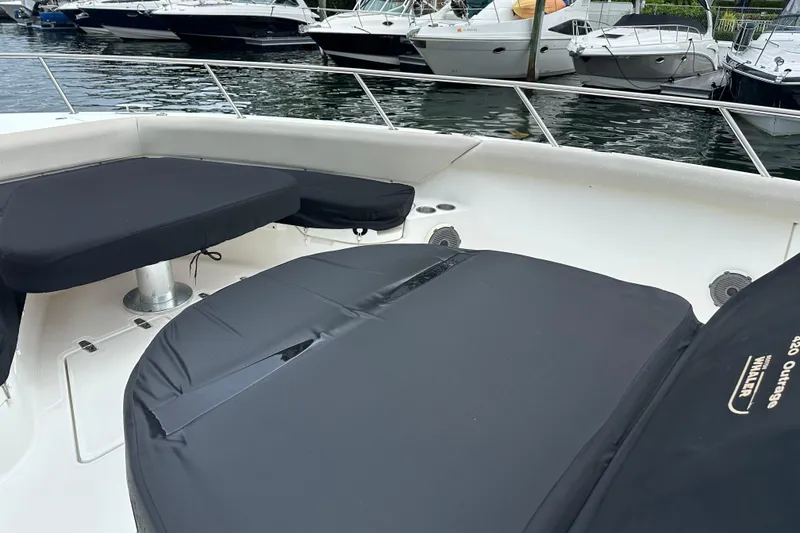 Slide: The Image of Boston Whaler 420 Outrage 2020 boat interior with covered seating at marina. - 15