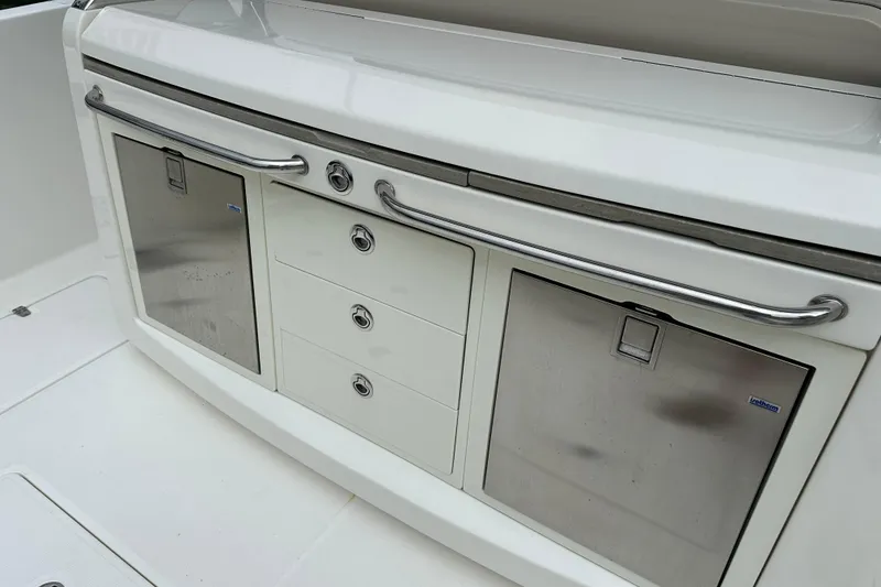 Slide: The Image of 2020 Boston Whaler 420 Outrage boat interior with stainless steel storage compartments. - 17