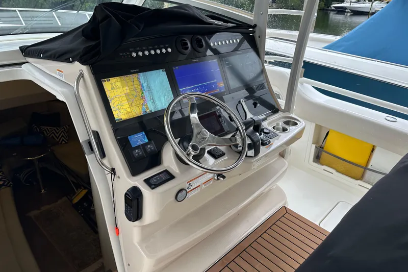 Slide: The Image of 2020 Boston Whaler 420 Outrage helm with advanced navigation displays and controls. - 19