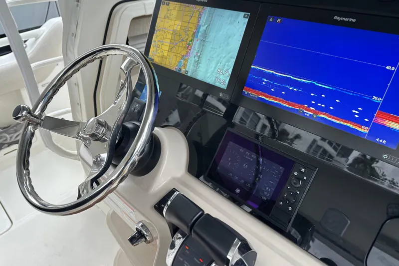 Slide: The Image of Steering console of 2020 Boston Whaler 420 Outrage with advanced navigation displays. - 22