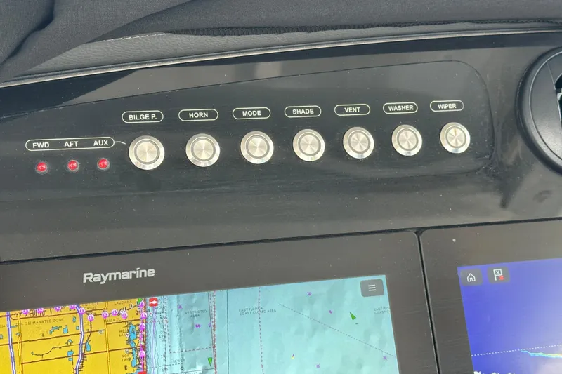 Slide: The Image of Control panel of a 2020 Boston Whaler 420 Outrage with Raymarine navigation display. - 24