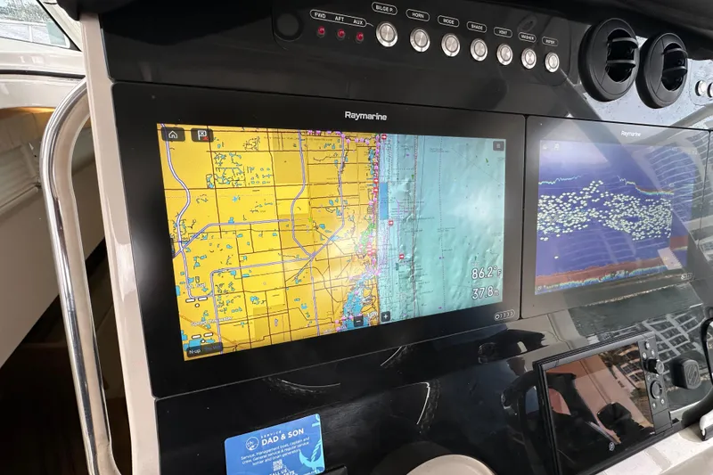 Slide: The Image of Dashboard of a 2020 Boston Whaler 420 Outrage with Raymarine navigation display. - 25