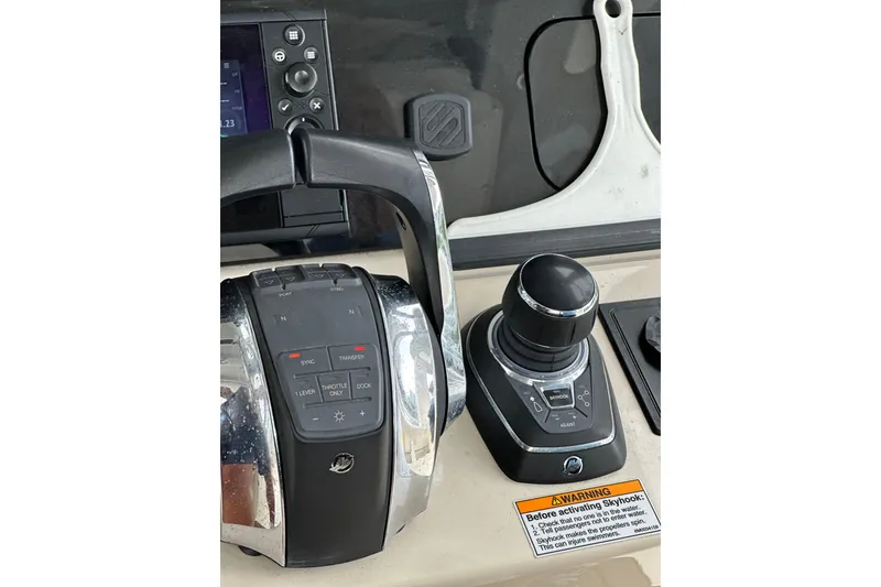Slide: The Image of Control panel of a 2020 Boston Whaler 420 Outrage boat, featuring joystick and throttle controls. - 28