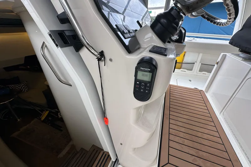 Slide: The Image of 2020 Boston Whaler 420 Outrage helm with Raymarine control and teak flooring. - 29