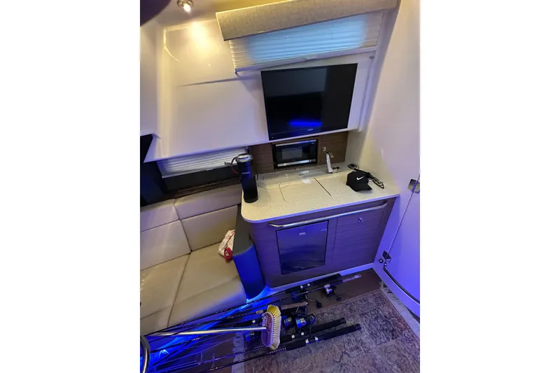 Slide: The Image of Interior of 2020 Boston Whaler 420 Outrage with kitchenette and seating area. - 34