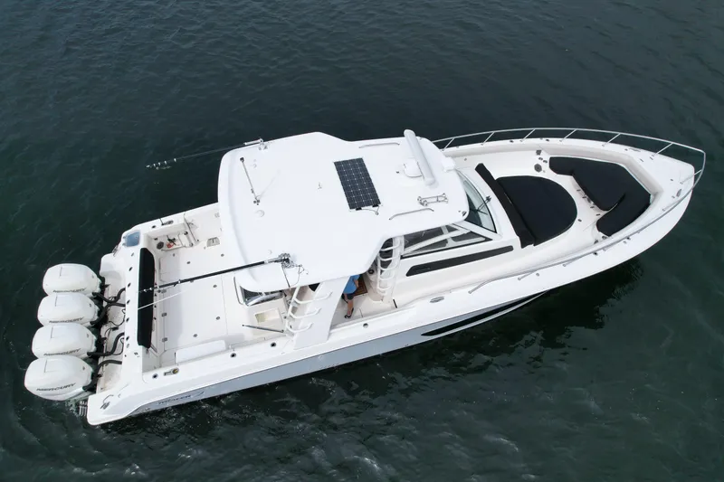 Slide: The Image of 2020 Boston Whaler 420 Outrage boat with four engines on open water. - 4