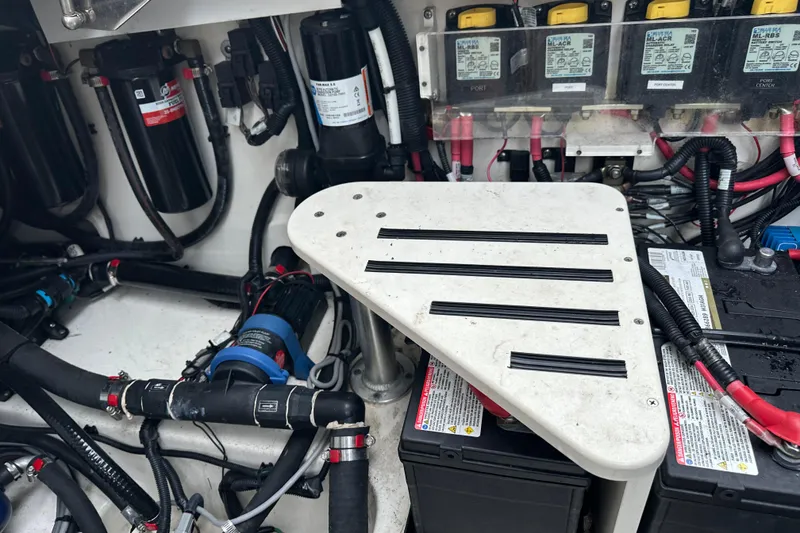 Slide: The Image of Engine compartment of a 2020 Boston Whaler 420 Outrage with visible wiring and components. - 45