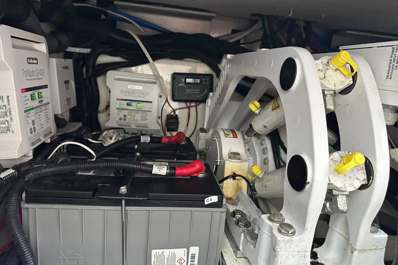 Slide: The Image of Engine compartment of a 2020 Boston Whaler 420 Outrage with batteries and electrical components. - 46