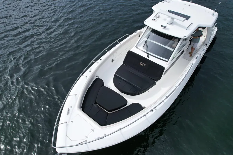 Slide: The Image of 2020 Boston Whaler 420 Outrage boat on water, featuring spacious deck and seating. - 5