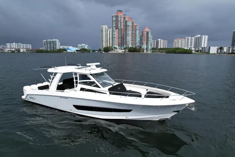 Slide: The Image of 2020 Boston Whaler 420 Outrage boat on water with city skyline background. - 7