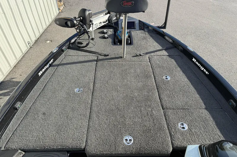 Slide: The Image of 2015 Ranger Z118 Comanche boat deck with carpeted surface and fishing equipment. - 12