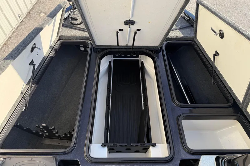 Slide: The Image of 2015 Ranger Z118 Comanche boat storage compartments open, showcasing spacious interior design. - 13