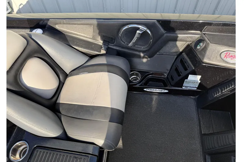 Slide: The Image of Interior of 2015 Ranger Z118 Comanche boat with seating and control panel. - 15