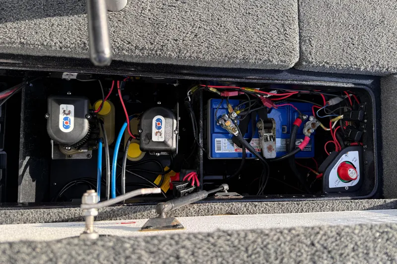 Slide: The Image of 2015 Ranger Z118 Comanche boat battery compartment with wiring and electrical components. - 19