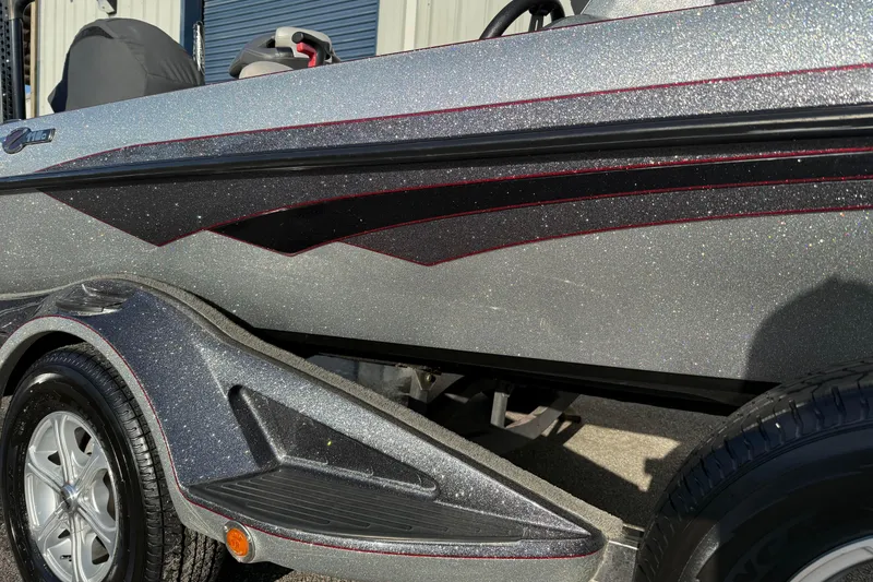 Slide: The Image of 2015 Ranger Z118 Comanche boat with metallic finish and sleek design details. - 2