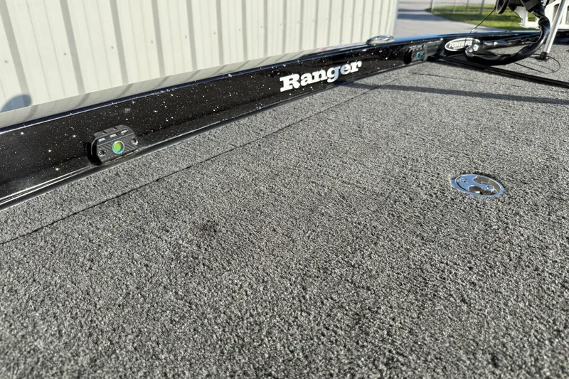 Slide: The Image of 2015 Ranger Z118 Comanche boat deck with textured surface and visible branding. - 22