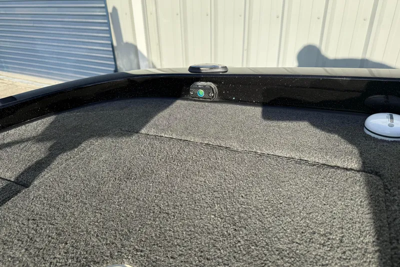 Slide: The Image of 2015 Ranger Z118 Comanche boat deck with carpet and storage compartments. - 23
