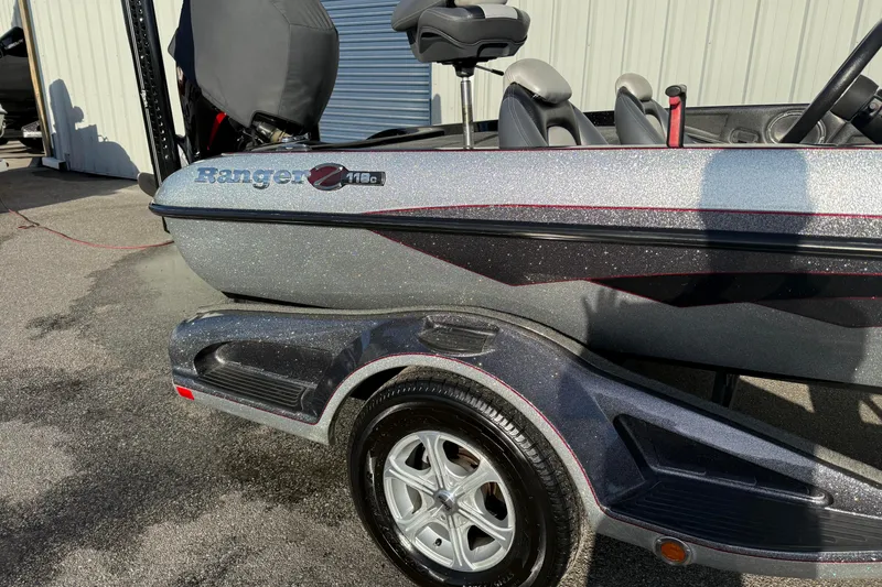 Slide: The Image of 2015 Ranger Z118 Comanche boat on trailer, metallic finish, parked outdoors. - 3