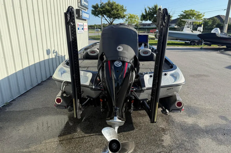 Slide: The Image of 2015 Ranger Z118 Comanche boat with powerful outboard motor, parked outdoors. - 6