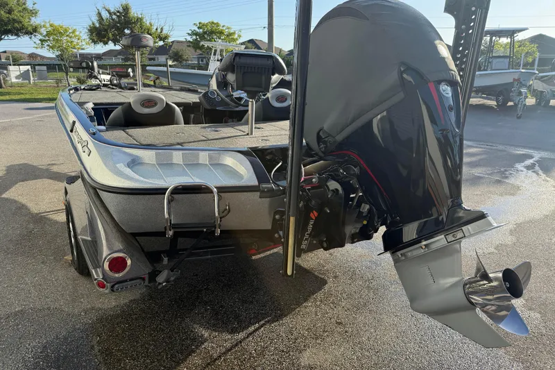 Slide: The Image of 2015 Ranger Z118 Comanche boat with powerful outboard motor in a sunny outdoor setting. - 7