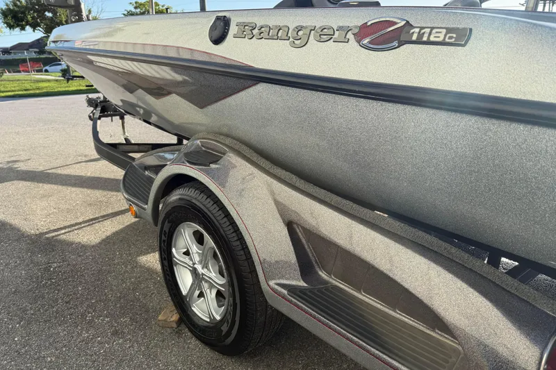 Slide: The Image of 2015 Ranger Z118 Comanche boat on trailer, showcasing sleek design and metallic finish. - 8
