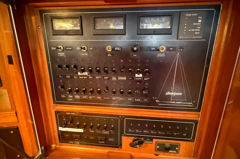 Slide: The Image of Control panel of a 1990 Baltic 52 yacht with various switches and gauges. - 19
