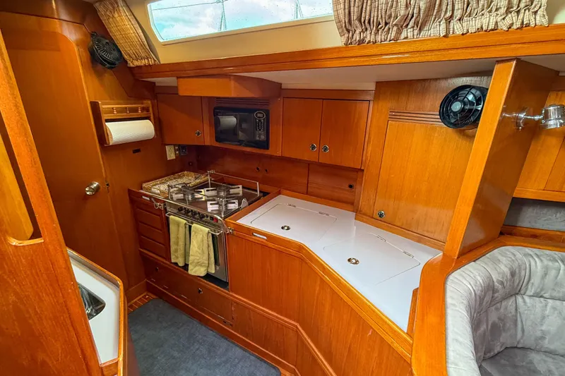 Slide: The Image of Cozy kitchen area in a 1990 Baltic 52 yacht with wooden cabinetry and modern appliances. - 27