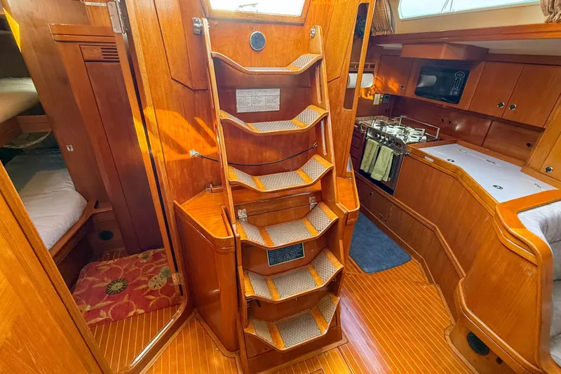 Slide: The Image of Interior of a 1990 Baltic 52 yacht with wooden finishes and compact kitchen. - 32