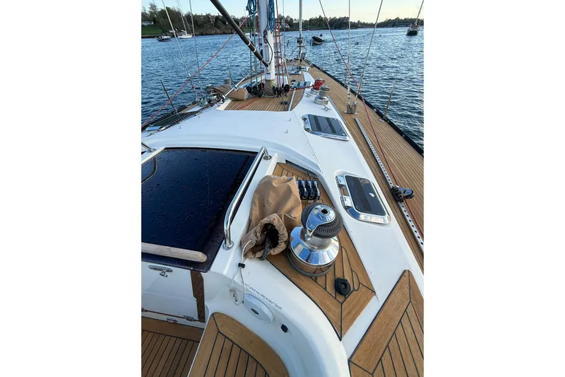 Slide: The Image of Deck view of a 1990 Baltic 52 sailboat with teak finish and winch. - 58