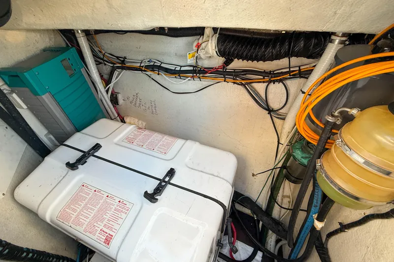 Slide: The Image of Engine compartment of a 1990 Baltic 52 yacht, featuring wiring and equipment. - 49
