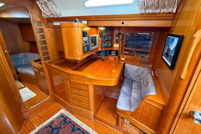 Slide: The Image of Luxurious 1990 Baltic 52 yacht interior with navigation station and cozy seating area. - 17