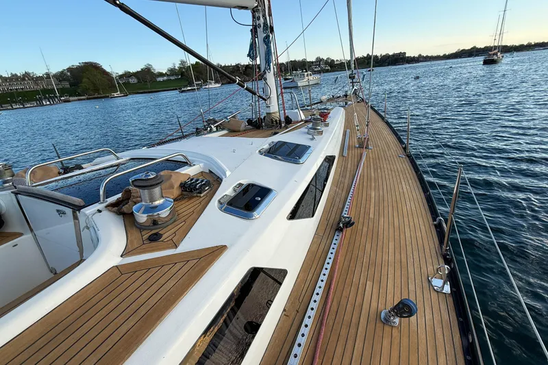 Slide: The Image of Sleek 1990 Baltic 52 yacht with teak deck, moored in serene waters. - 54