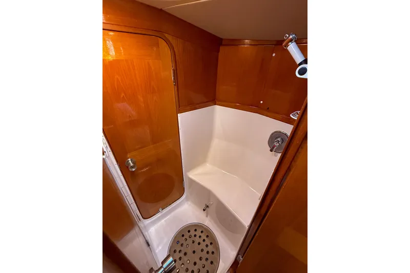Slide: The Image of 1990 Baltic 52 yacht bathroom with wooden door and compact shower area. - 26