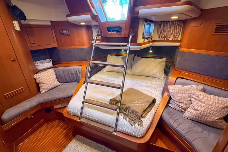 Slide: The Image of Luxurious cabin interior of a 1990 Baltic 52 yacht with cozy bedding and seating. - 37