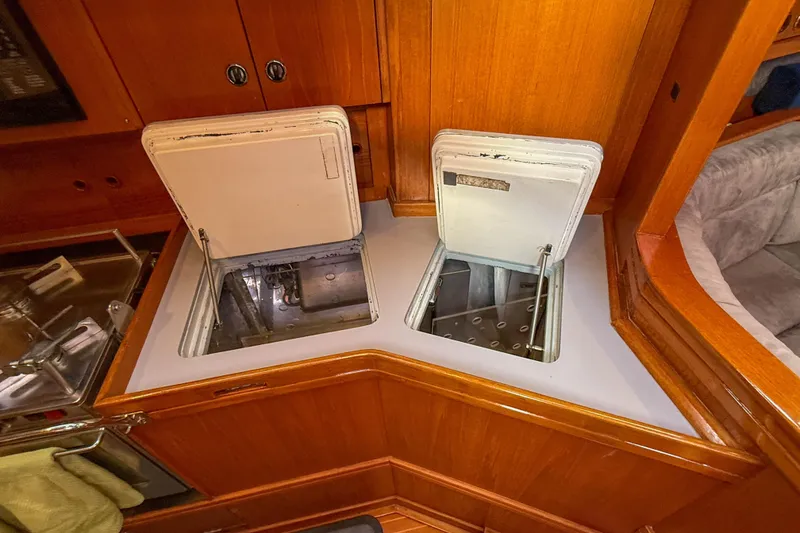 Slide: The Image of Interior of 1990 Baltic 52 yacht showing open storage compartments in wooden cabinetry. - 31
