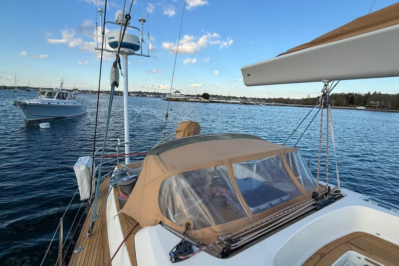 Slide: The Image of Sailing yacht Baltic 52, 1990 model, anchored in a serene harbor with clear skies. - 56
