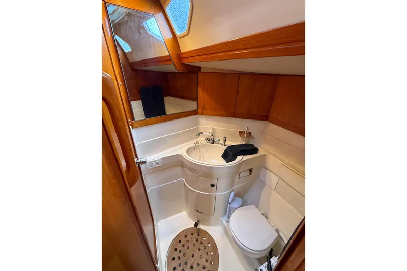 Slide: The Image of Luxurious bathroom in a 1990 Baltic 52 yacht, featuring wood accents and modern fixtures. - 25