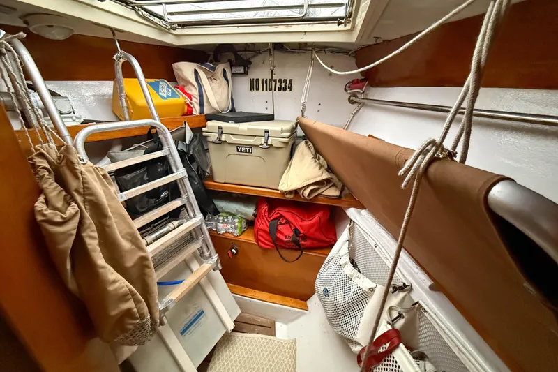 Slide: The Image of Interior storage area of a 1990 Baltic 52 sailboat, featuring organized gear and equipment. - 47
